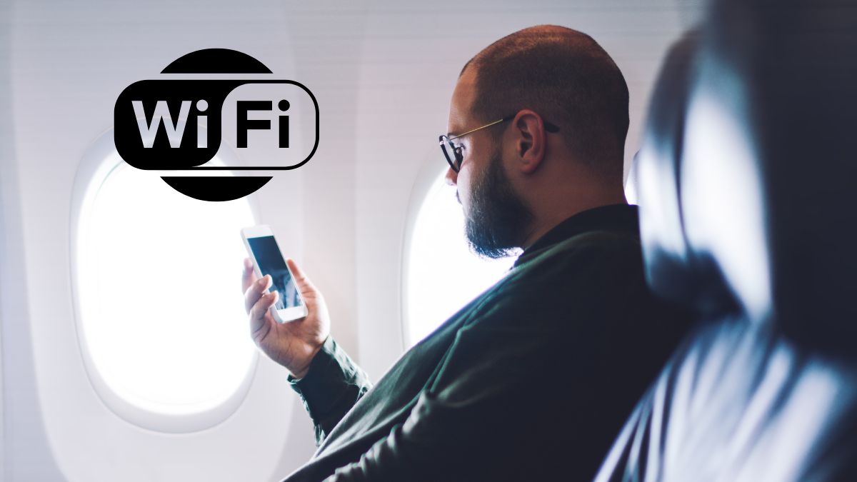 Wizz Air wprowadza WiFi na pokładzie Foto: mężczyzna patrzący na ekran telefonu w samolocie