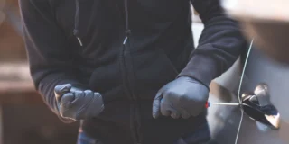 Ranking 10 najbardziej niebezpiecznych miejsc w UK Foto: włamywacz próbuje otworzyć samochód